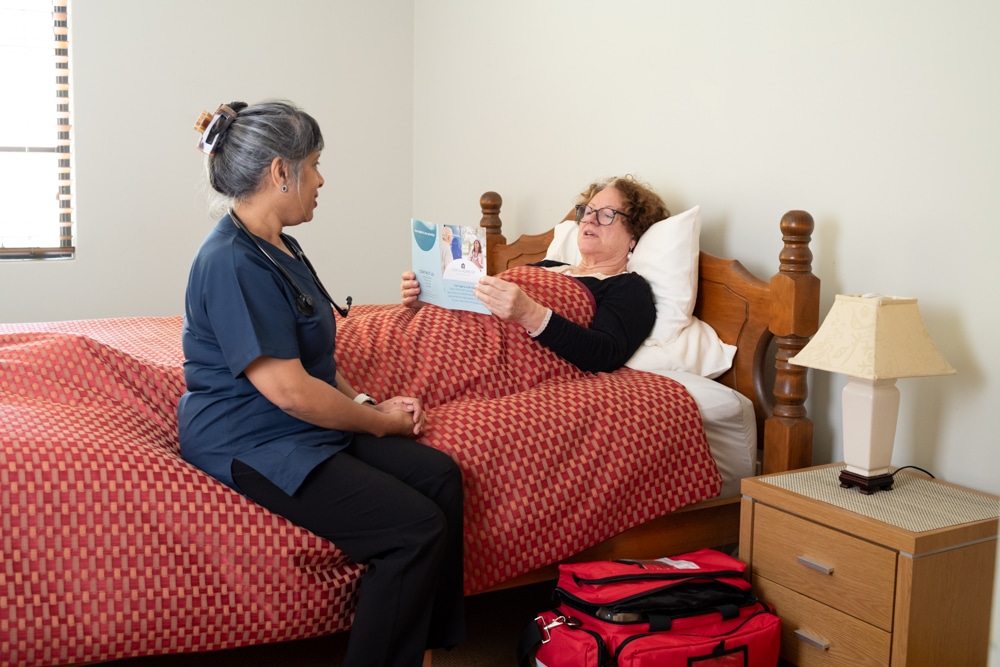 GP providing ongoing care to an older patient at home