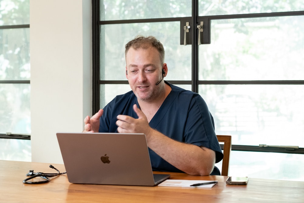 Perth Home GP Telehealth GP undertaking a telehealth consulation on his laptop